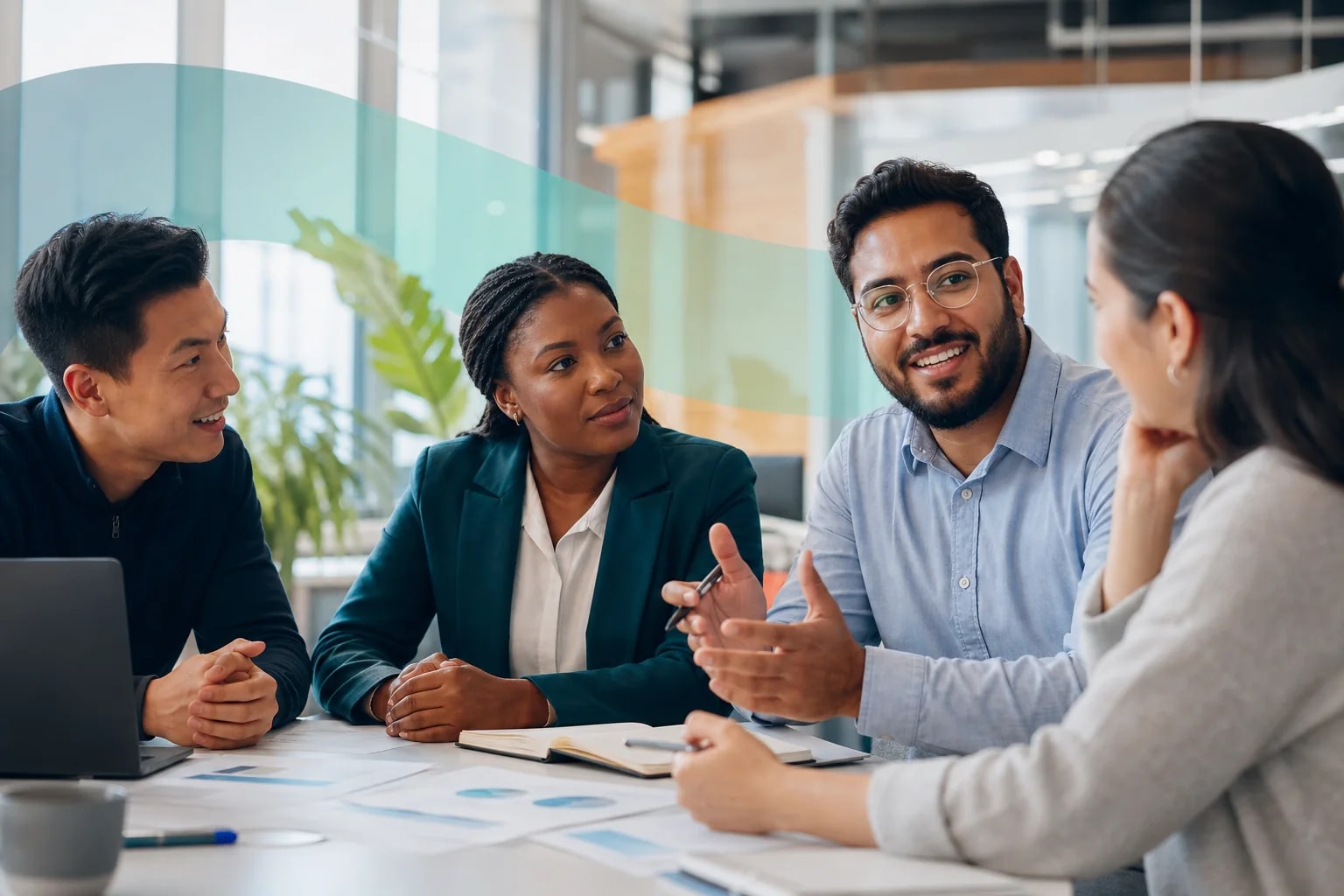 Four professionals discuss ideas around a workshop table.